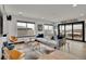 Modern living room with hardwood floors, stylish furniture, and access to an outdoor patio at 21345 E 59Th Dr, Aurora, CO 80019