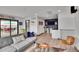 Inviting living room featuring a wet bar, comfortable seating, and access to an outdoor space at 21345 E 59Th Dr, Aurora, CO 80019