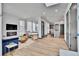 Open-concept living room with fireplace and modern furnishings, seamlessly connecting to the kitchen and dining area at 21345 E 59Th Dr, Aurora, CO 80019