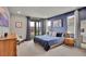 Inviting main bedroom with blue accents, natural light, and plush bedding at 21345 E 59Th Dr, Aurora, CO 80019