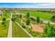 Aerial view of community park featuring green space, walking paths, and lush landscaping at 21345 E 59Th Dr, Aurora, CO 80019