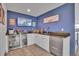 Stylish wet bar featuring white cabinets, granite countertops, and a beverage fridge at 21345 E 59Th Dr, Aurora, CO 80019