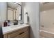 This bathroom features a vanity with modern fixtures and a shower/tub combo with white subway tile at 3141 S Tamarac Dr # 202E, Denver, CO 80231