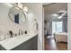 A view from the bathroom to the bedroom, showing updated fixtures and a marble countertop at 3141 S Tamarac Dr # 202E, Denver, CO 80231
