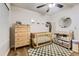 A charming Bedroom is shown with wooden furnishings, a crib, changing table, and a decorative rug at 3141 S Tamarac Dr # 202E, Denver, CO 80231
