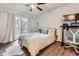 Bright bedroom with balcony access and a workspace area at 3141 S Tamarac Dr # 202E, Denver, CO 80231