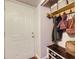 Entryway with shoe storage bench and hooks for coats and bags near the front door at 3141 S Tamarac Dr # 202E, Denver, CO 80231