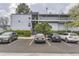 Light blue building with multiple levels and parking in front, showcasing the building's facade and available parking at 3141 S Tamarac Dr # 202E, Denver, CO 80231