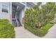 The building's entrance with stairs, brick detail, and surrounded by lush greenery at 3141 S Tamarac Dr # 202E, Denver, CO 80231