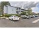 Light blue building with multiple levels and parking in front, showcasing the building's facade and available parking at 3141 S Tamarac Dr # 202E, Denver, CO 80231