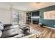 Cozy living room with fireplace, TV, and sliding door to balcony at 3141 S Tamarac Dr # 202E, Denver, CO 80231