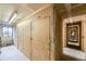 Storage units located within the building with light colored doors, secure latches, and overhead lighting at 3141 S Tamarac Dr # 202E, Denver, CO 80231