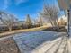 Spacious backyard with a concrete patio and mature trees at 4591 S Fairplay St, Aurora, CO 80015