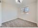 Bedroom with light brown carpet, a large window, light gray walls, and a modern light fixture at 4591 S Fairplay St, Aurora, CO 80015
