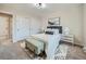 Bedroom featuring a bed, two side tables, a window, light gray walls, and geometric patterned rug at 4591 S Fairplay St, Aurora, CO 80015
