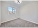 Bright bedroom features a neutral palette, plush carpeting, and ample natural light from a large window at 4591 S Fairplay St, Aurora, CO 80015