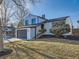 Well-kept house with a gray garage door and a manicured lawn at 4591 S Fairplay St, Aurora, CO 80015