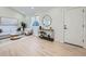 Airy living room with light hardwood floors, white furniture, and natural light at 4591 S Fairplay St, Aurora, CO 80015