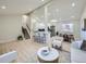 Spacious open-concept living space with a modern kitchen and a cozy seating area at 4591 S Fairplay St, Aurora, CO 80015