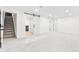 Spacious basement featuring an adjacent laundry room, new carpet, and ample lighting at 6142 Dudley Ct, Arvada, CO 80004