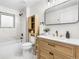 Stylishly renovated bathroom with a modern vanity, marble-like tiling, and sleek fixtures at 6142 Dudley Ct, Arvada, CO 80004