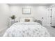 Bright bedroom featuring a large bed with a floral comforter and carpeted floors at 6142 Dudley Ct, Arvada, CO 80004