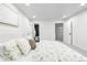 Bright bedroom featuring a large bed with a floral comforter and carpeted floors and attached bath at 6142 Dudley Ct, Arvada, CO 80004
