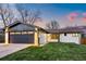 A charming single-story home with a well-manicured lawn and an attached garage at 6142 Dudley Ct, Arvada, CO 80004