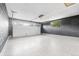 Spacious garage with high ceilings, finished concrete floor and gray brick walls at 6142 Dudley Ct, Arvada, CO 80004