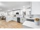 Updated kitchen featuring white cabinets, stainless steel appliances, and quartz countertops at 6142 Dudley Ct, Arvada, CO 80004