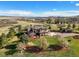 Expansive aerial view of home, well manicured lawn and landscaping, large trees, and beautiful mountain views at 3891 Windchant Cir, Castle Rock, CO 80104