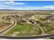 A winding driveway leads to this stunning estate, set against a picturesque landscape at 3891 Windchant Cir, Castle Rock, CO 80104