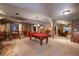 Spacious basement featuring a pool table, bar area, seating, and neutral-colored carpeting at 3891 Windchant Cir, Castle Rock, CO 80104