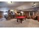 Basement recreation space with pool table, bar area, seating area, and neutral carpet at 3891 Windchant Cir, Castle Rock, CO 80104