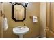 Half bathroom featuring pedestal sink, octagon mirror, towel rack, and tile floors at 3891 Windchant Cir, Castle Rock, CO 80104