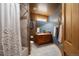 Bathroom with blue accent walls, tile floors, vanity, and shower with white curtain at 3891 Windchant Cir, Castle Rock, CO 80104