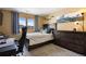 Comfortable bedroom with a queen-size bed, a window with nice view, and a dresser at 3891 Windchant Cir, Castle Rock, CO 80104