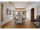Formal dining room with wood trim, hardwood floors, and a view of the snowy outdoors at 3891 Windchant Cir, Castle Rock, CO 80104