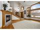 Bright foyer with fireplace, staircase, and large windows, offering a warm welcome at 3891 Windchant Cir, Castle Rock, CO 80104