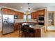 Close up of a gourmet kitchen with wood cabinetry, stainless steel appliances, and a center island with bar seating at 3891 Windchant Cir, Castle Rock, CO 80104