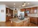 Charming kitchen with wood cabinets, granite countertops, a center island with cooktop, and stainless steel appliances at 3891 Windchant Cir, Castle Rock, CO 80104