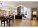 Open-concept living area with stone fireplace, vaulted ceilings, and beautiful hardwood floors at 3891 Windchant Cir, Castle Rock, CO 80104
