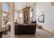 Cozy living room with stone fireplace, high ceilings, and a large window overlooking the landscape at 3891 Windchant Cir, Castle Rock, CO 80104