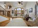 Elegant living room featuring a staircase, large bay window with stunning views, and cozy seating area at 3891 Windchant Cir, Castle Rock, CO 80104