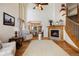 Inviting living room with fireplace, hardwood floors, and staircase to an upper level at 3891 Windchant Cir, Castle Rock, CO 80104