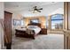 Spacious main bedroom featuring large windows with a view, ceiling fan and neutral carpet at 3891 Windchant Cir, Castle Rock, CO 80104