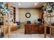 View of the office with an executive desk, built-in shelving, and neutral colored carpet and walls at 3891 Windchant Cir, Castle Rock, CO 80104