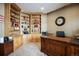 Office with custom built-in shelving, hardwood floors, and a large wooden desk at 3891 Windchant Cir, Castle Rock, CO 80104