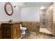 Bathroom featuring decorative tiling, ornate vanity, oval mirror, and a glass enclosed shower at 8518 Thunderbird Rd, Parker, CO 80134