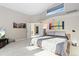 Large main bedroom with natural light, colorful artwork, a tv and ensuite bathroom at 8518 Thunderbird Rd, Parker, CO 80134